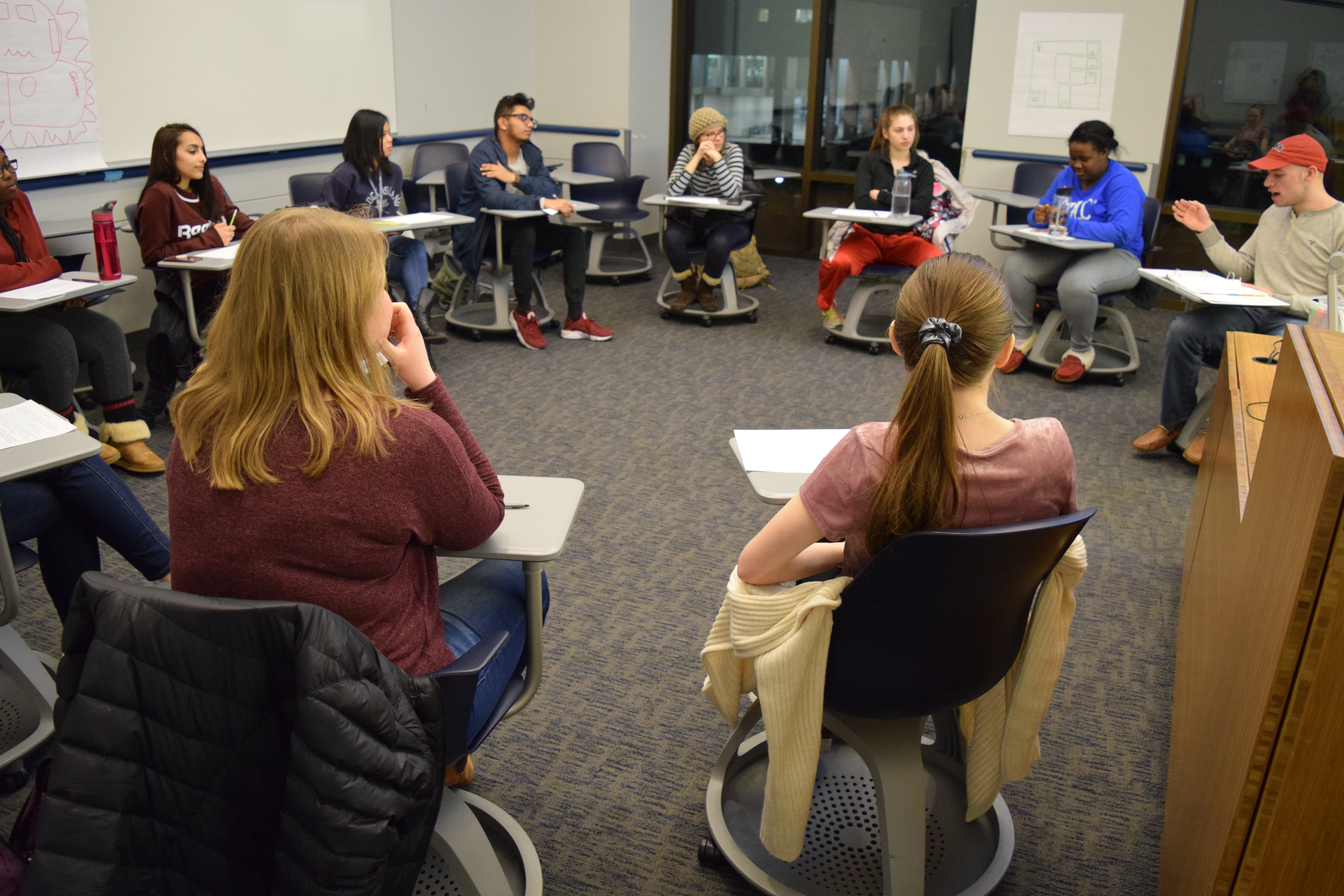 Workshop students sit in a circle and have a discussion