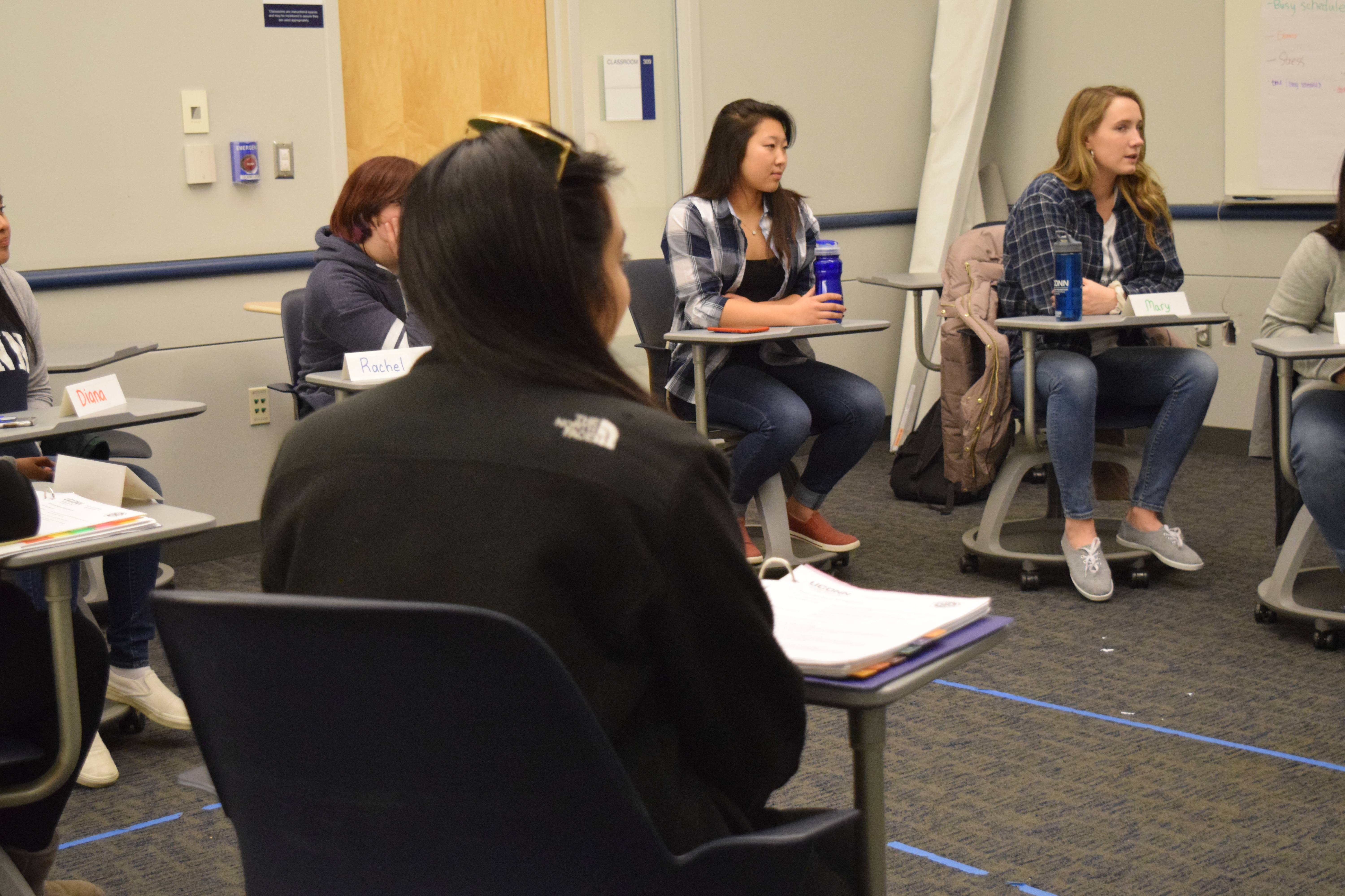 Students sitting in a circle in a conversation with each other