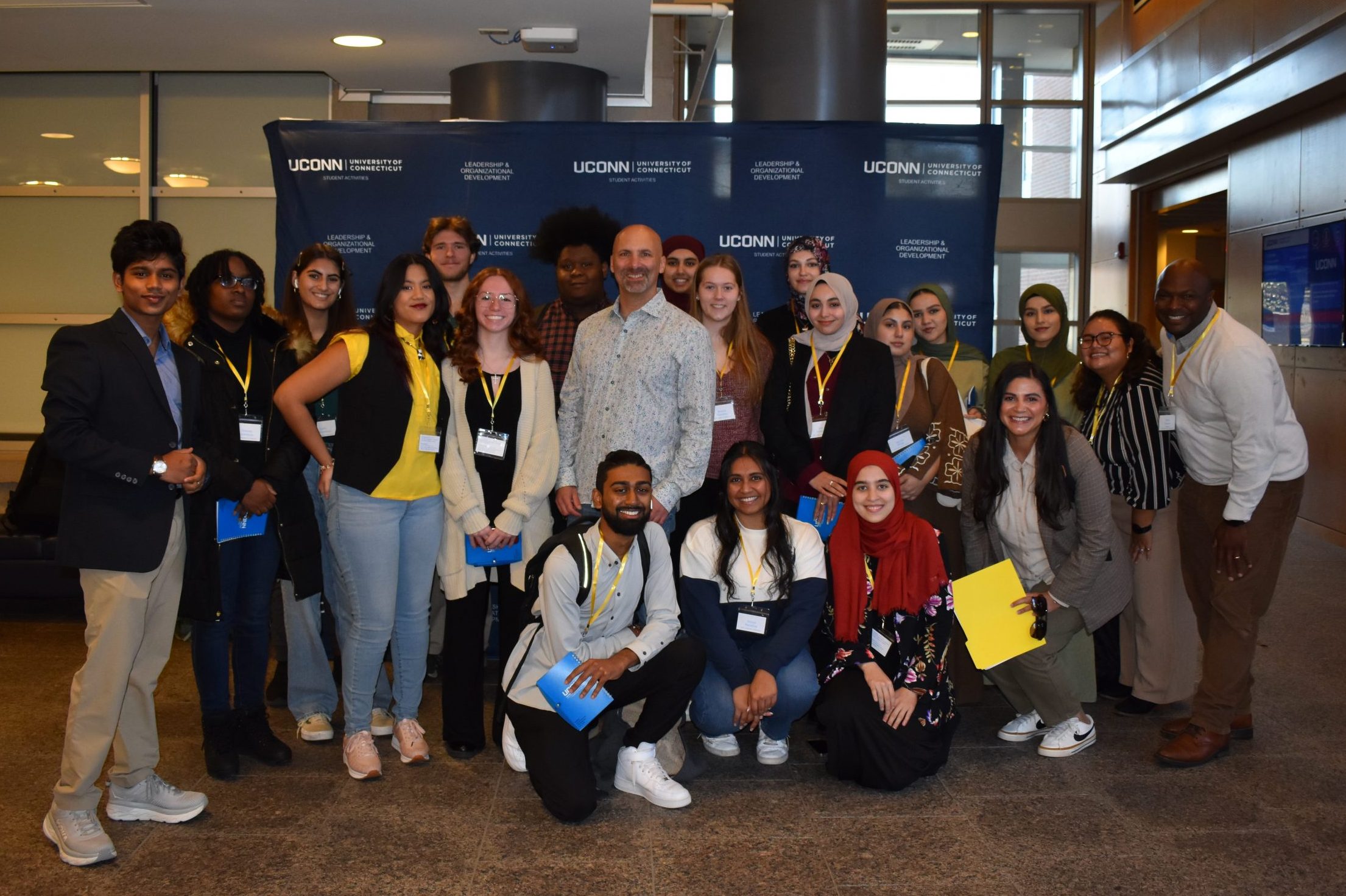 Group of UConn staff, faculty, and students pose for camera at Leadership Conference